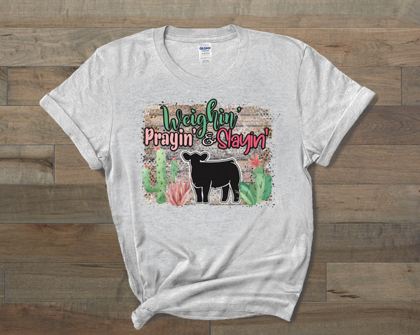 Weighin' Prayin' Slayin' Show Steer Tee